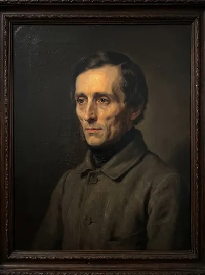 Portrait of a tall thin figure half lost in shadow, features barely resolved.